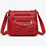 Vintage crossbody tas van kunstleer met hartdetails