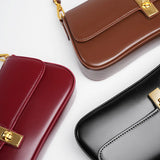 Compacte crossbody tas met klepsluiting en gouden detail
