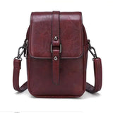 Compacte crossbody tas met verstelbare schouderband en gespsluiting